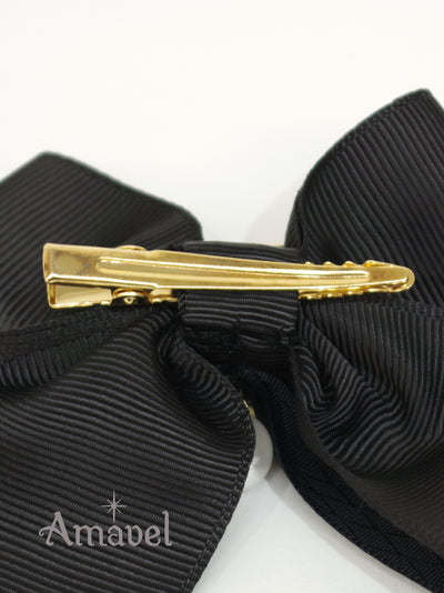 Double ribbon clip with monogram buckle