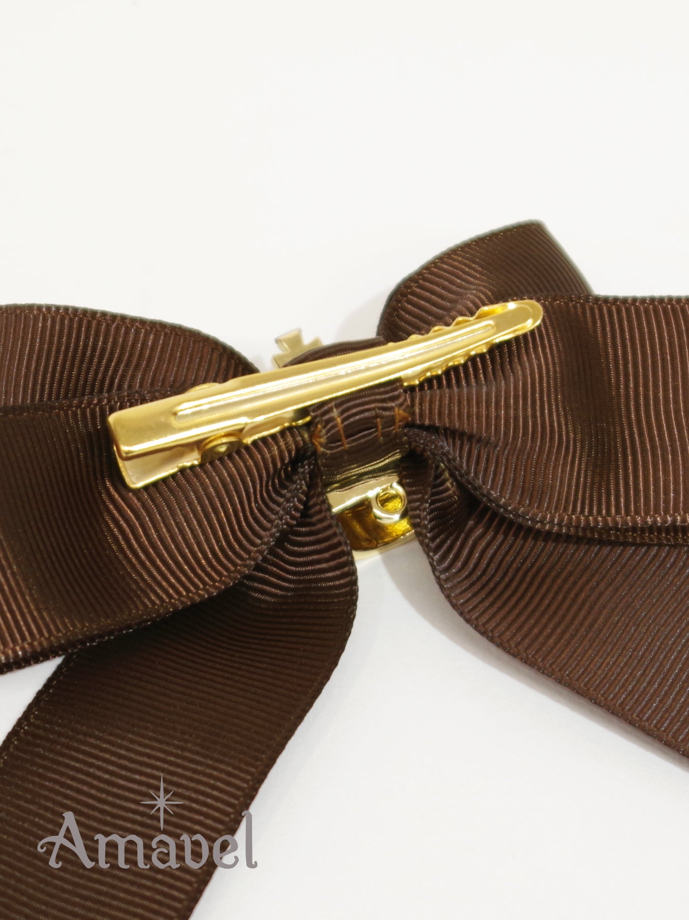 Double ribbon clip with crown charm